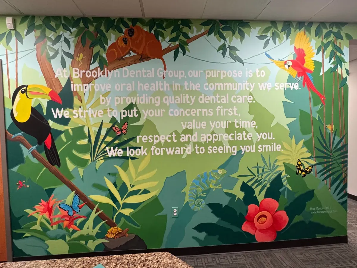 A jungle mural at Brooklyn Dental Group with the office’s mission painted on it